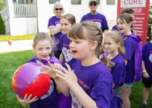 Ella smiling and playing with friends at Ella's Race 2019