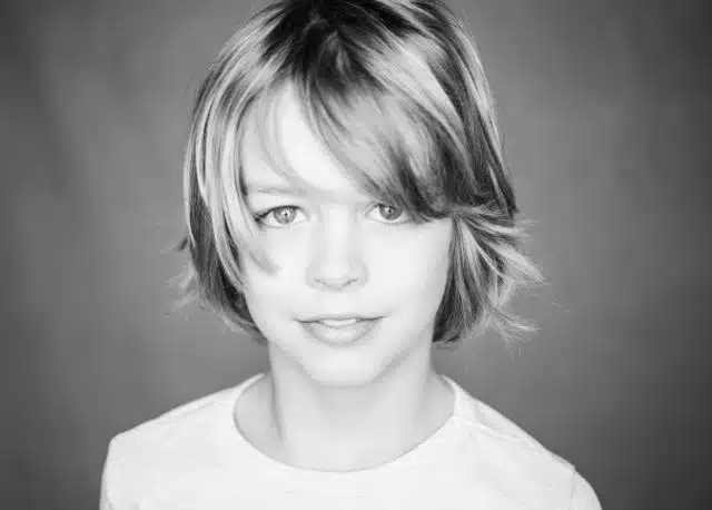 Black and white photo of Jack, who has shiny skater hair.