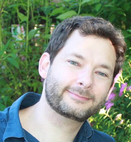 a man smiling for a headshot