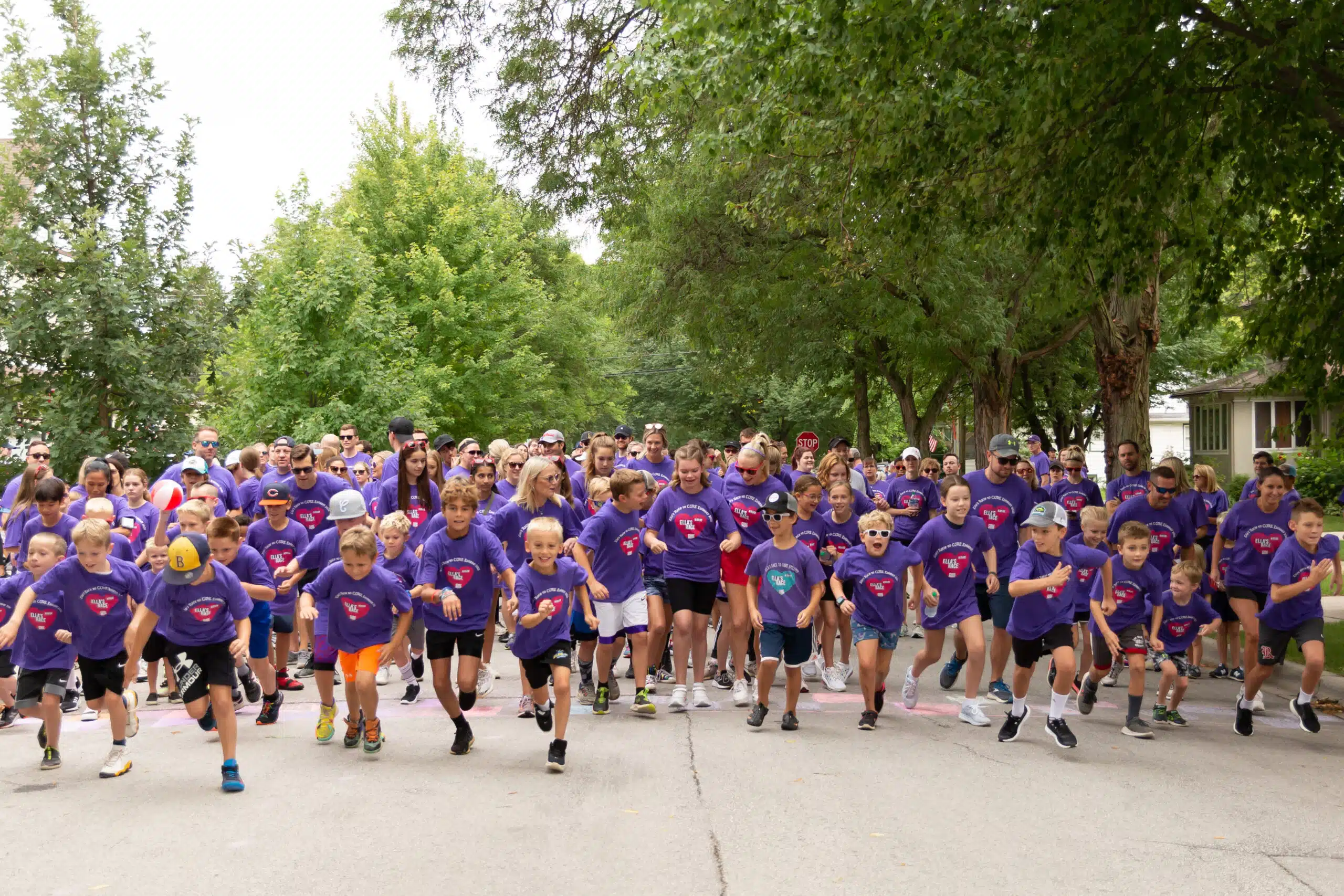 Crowd of people running in a line outdoors for Ella's race.