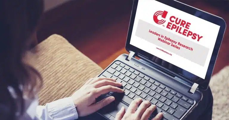 Person using laptop to explore the latest advancements in the cure for epilepsy