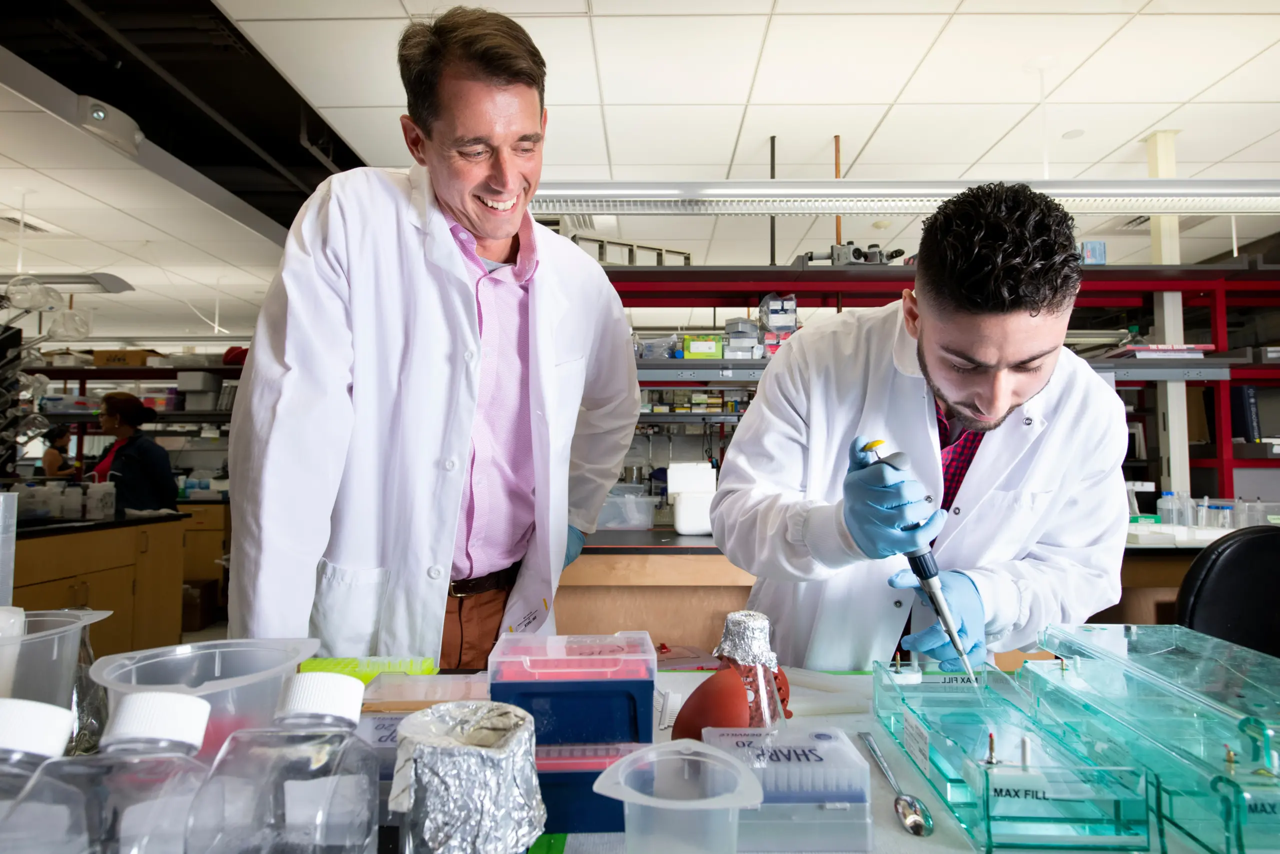 Two doctors in science laboratory using tools for research