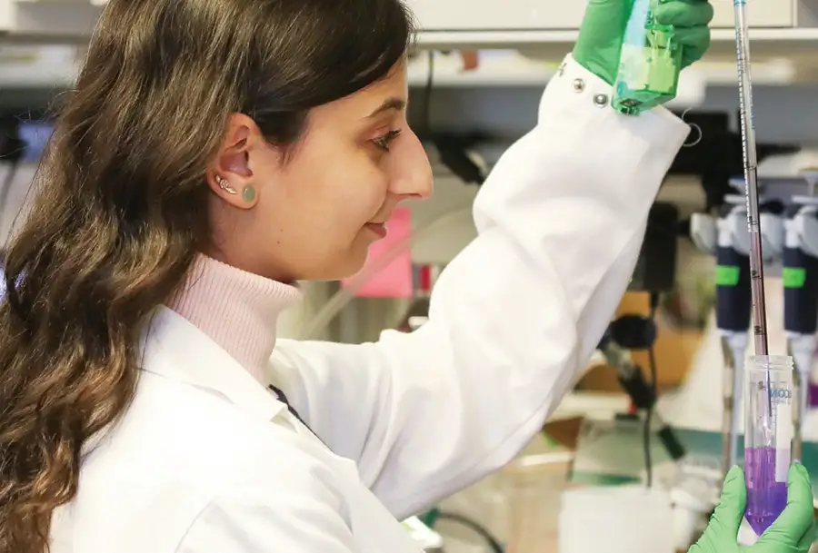 Woman in a laboratory wearing lab coat doing research