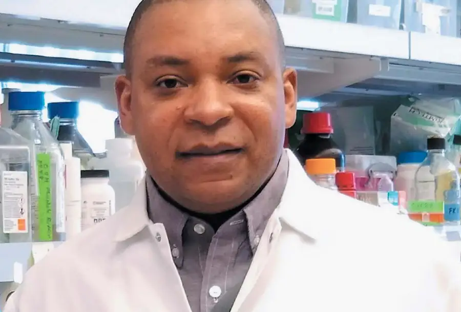 Photo of researcher wearing a lab coat in a laboratory setting