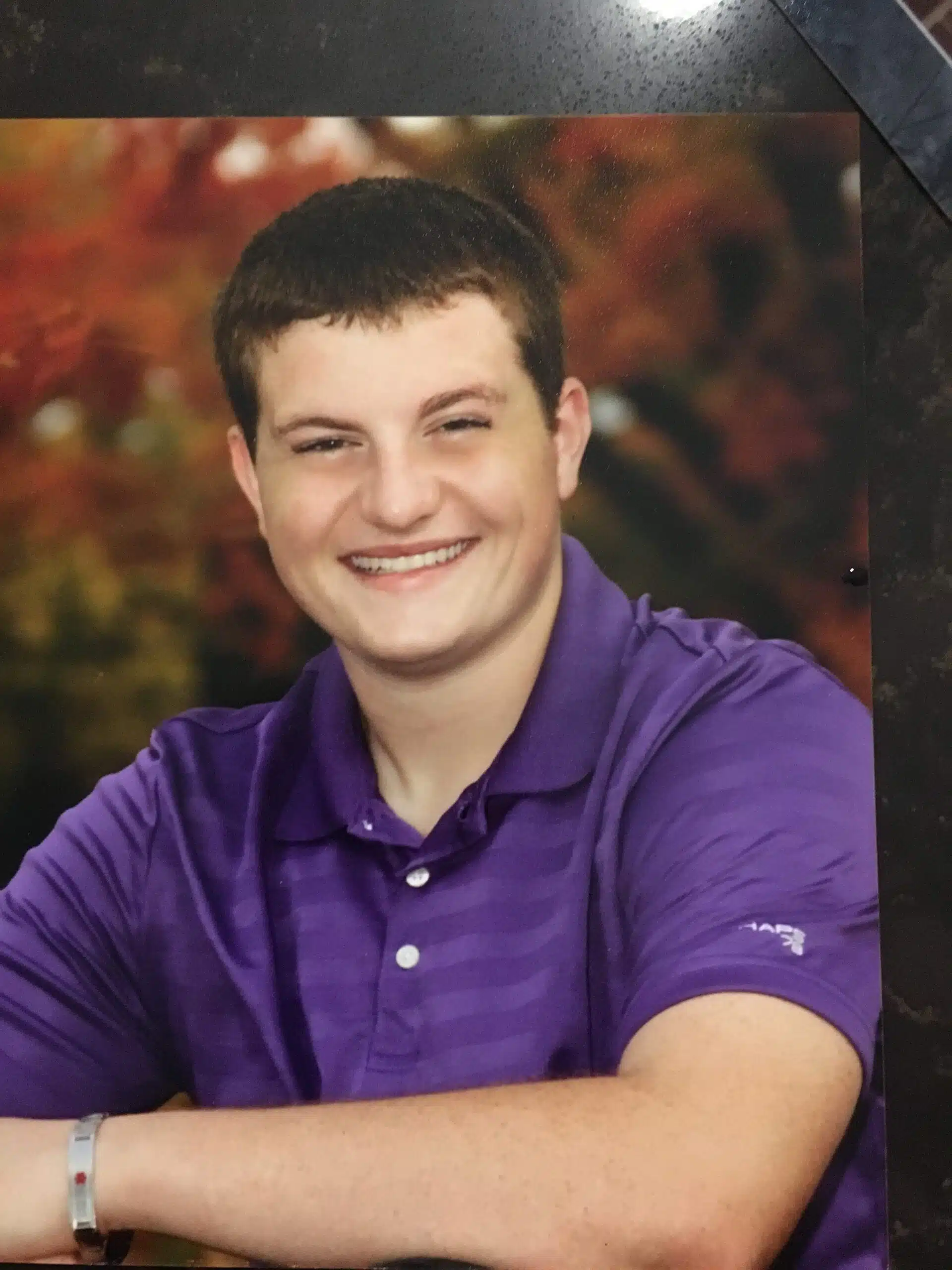 Anthony Maffie smiling at camera wearing purple shirt