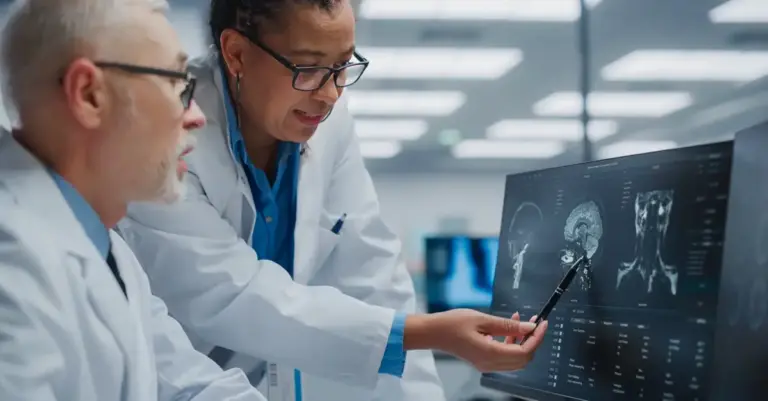 Two doctors look at computer screen with epilepsy diagnostic tests