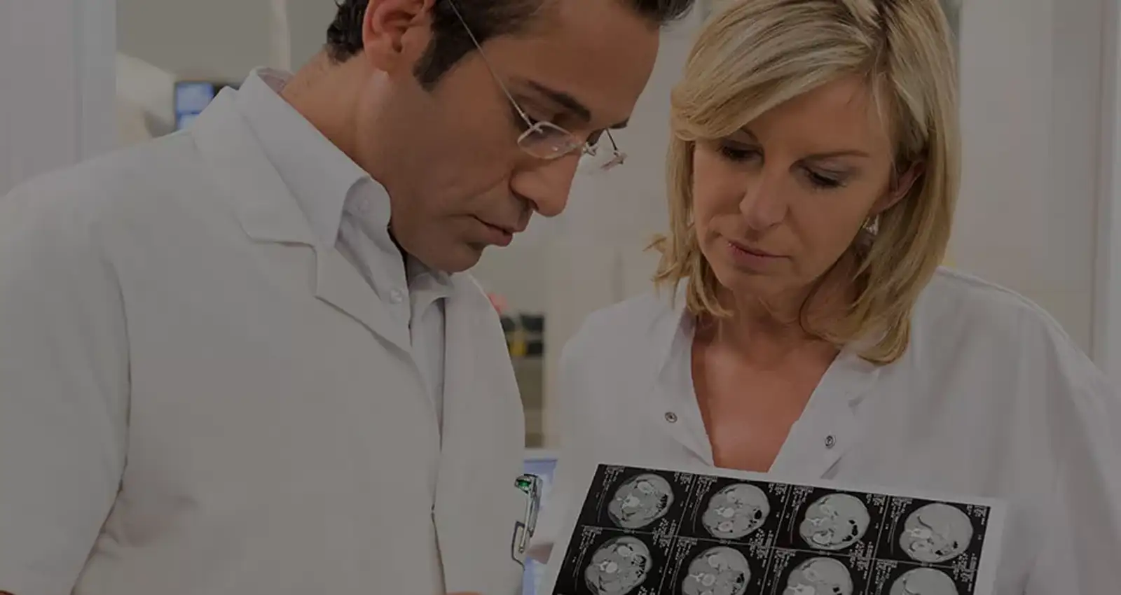 Two doctors look at epilepsy research documents in lab coats