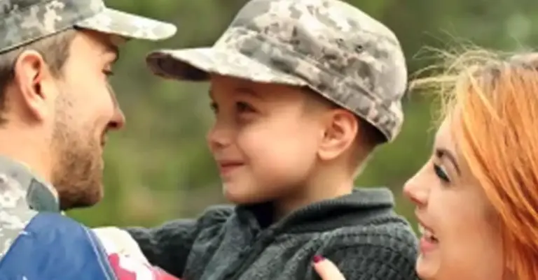Family wearing military uniform hats smiling at each other