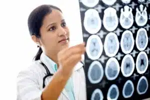 A doctor is reviewing brain scan of a patient.