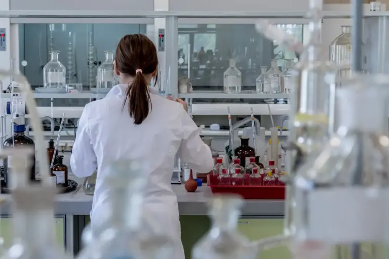 Researcher wearing a lab coat in a lab.