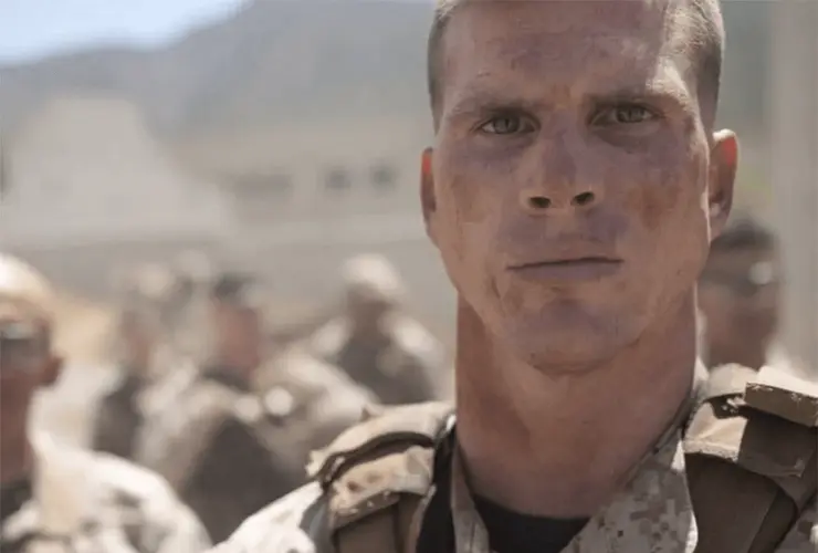 A closeup of a soldier's face standing at attention.