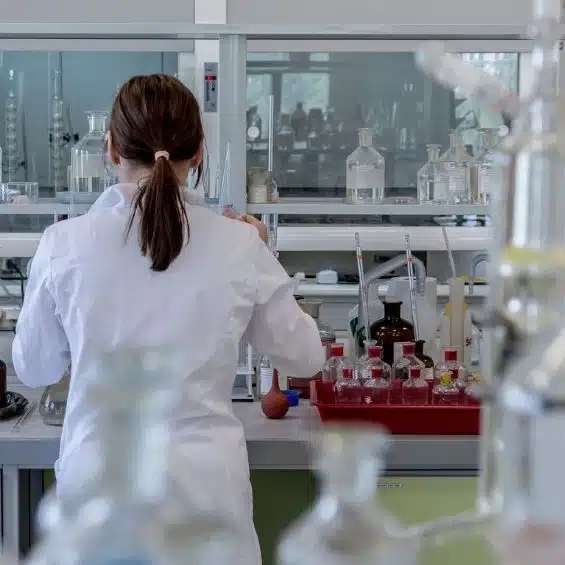 A person in a laboratory setting using lab equipment.