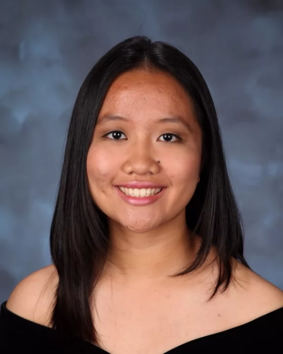 Photo of young woman with epilepsy smiling for headshot.