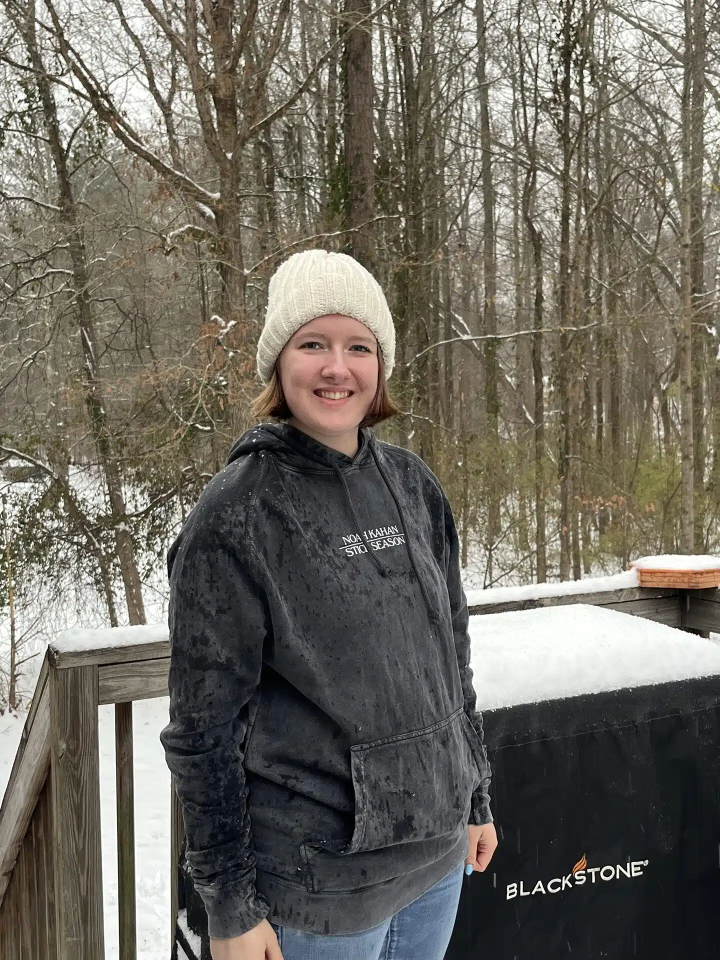Woman with epilepsy, Olivia, standing smiling at camera